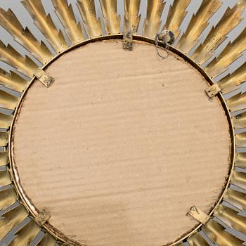 A 20th century metal sun mirror.
