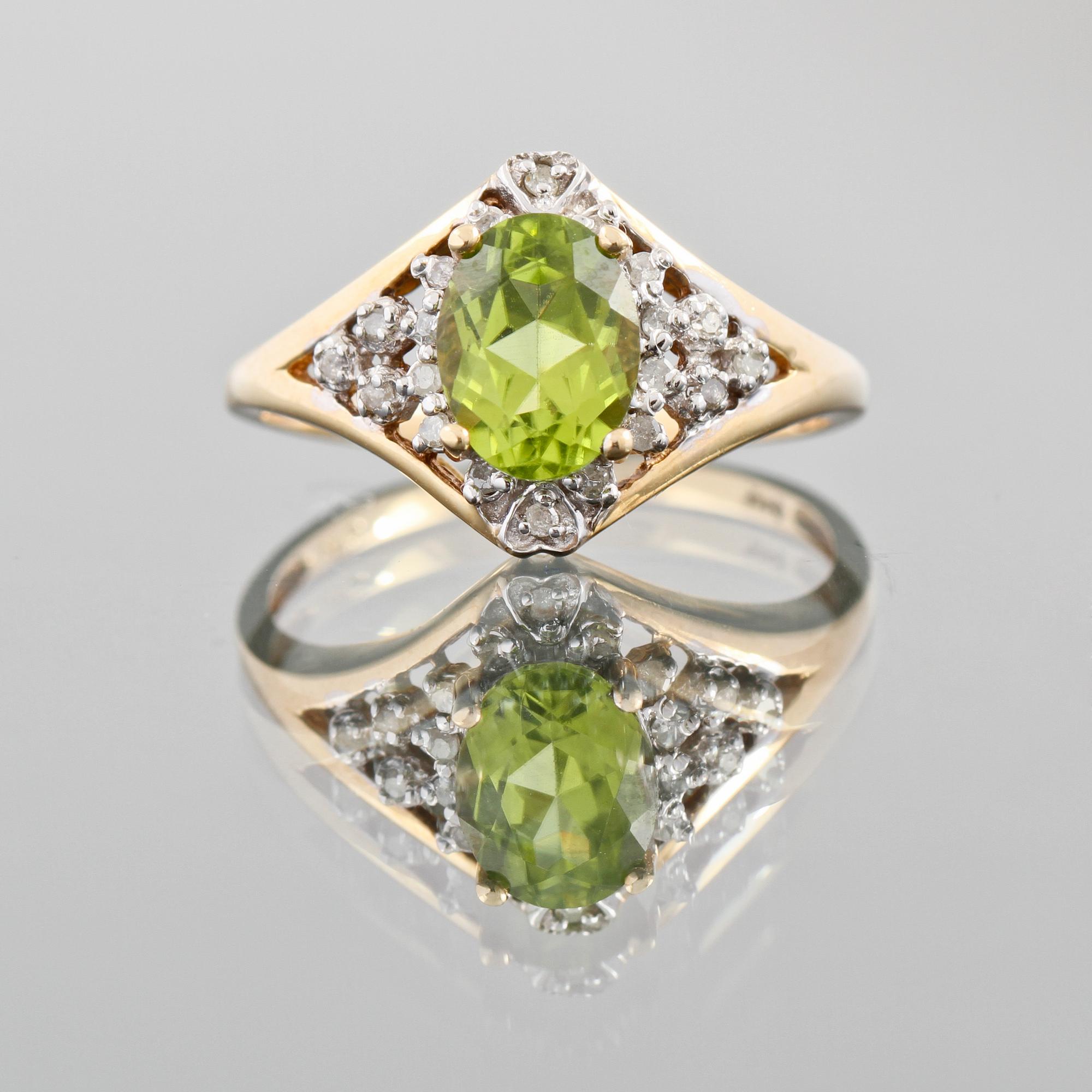 RING, 14K guld med ovalslipad peridot samt fasettslipade diamanter ca 0.50 ct. Vikt 2,8 g.