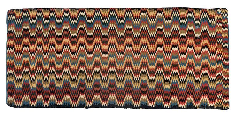 A carriage cushion, double-interlocked tapestry, ca 47 x 104 cm, Oxie or Skytts district, early 19th century.