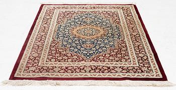 A rug, silk Quum, signed, c. 106 x 80 cm.