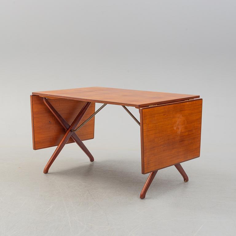 A teak veneer and stained beech dining table, mid 20th Century.