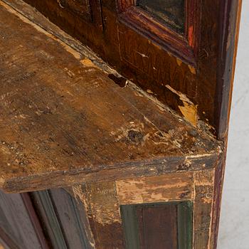 A corner cupboard, dated 1779.