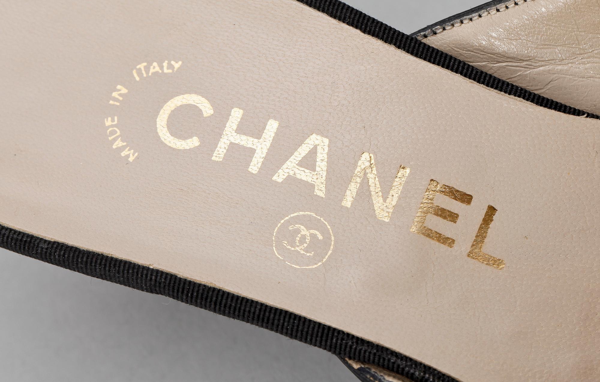 A pair of black slip-in by Chanel.