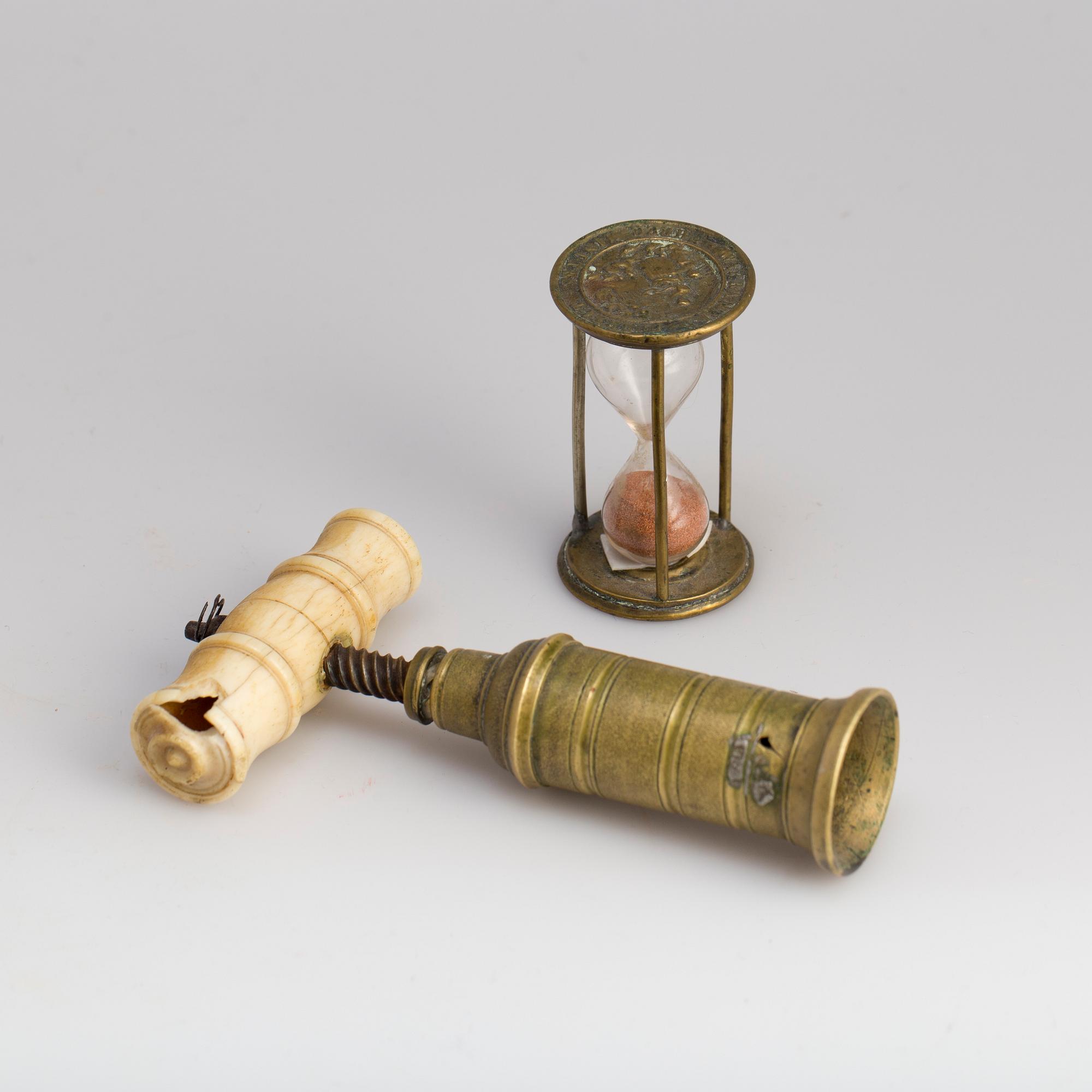 A brass cork screw and hourglass 19th century.