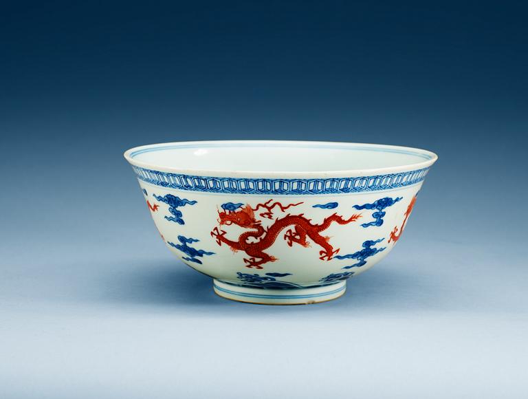 A blue and white bowl with a dragon in copper red, Qing dynasty with Xuande six character mark.