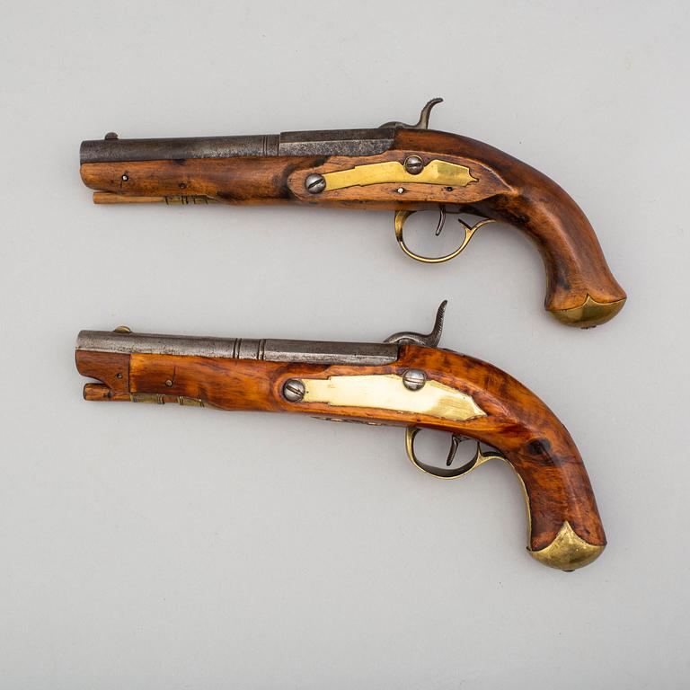 Two Swedish percussion pistols with birch stocks and brass mounts.