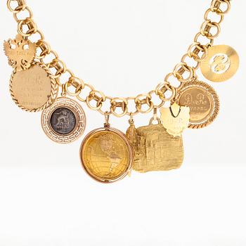 An 18K gold bracelet with large charms.