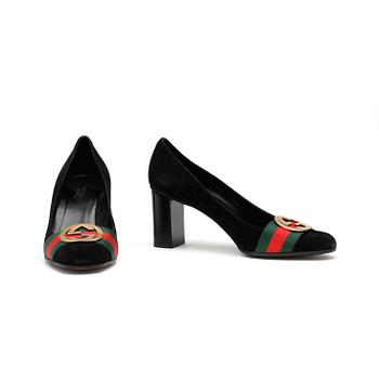 GUCCI, a pair of black suede pumps.