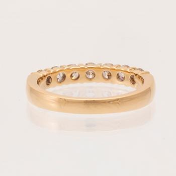 An 18K gold half-eternity ring set with round brilliant-cut diamonds.