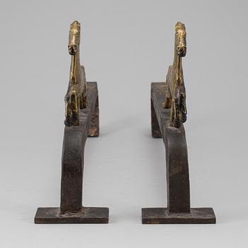 A PAIR OF IRON AND BRASS ANDIRONS by Tore Kullander, Borås 1943.