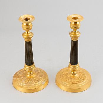 A pair of French Empire candlesticks.