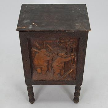 A 1920s cabinet with a relief.