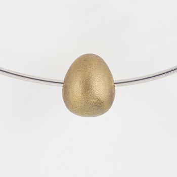 Gunilla Lantz, silver and gilded egg necklace.