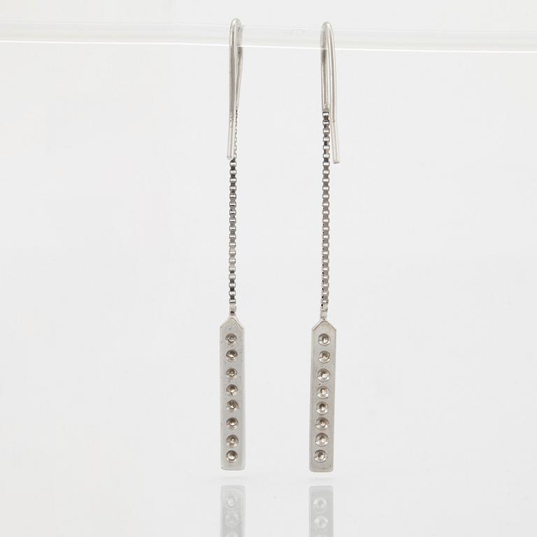 A pair of 18K white gold earrings set with round brilliant-cut diamonds.