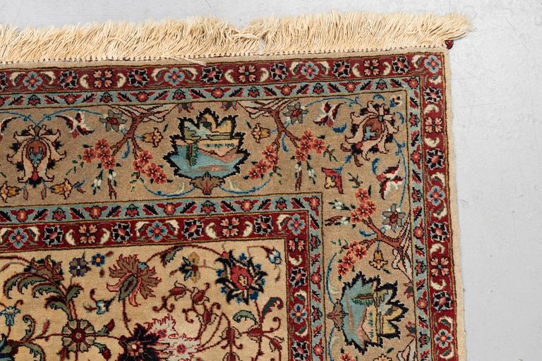 A carpet, semi-antique Tabriz, figural, signed, ca 234 x 170 cm.