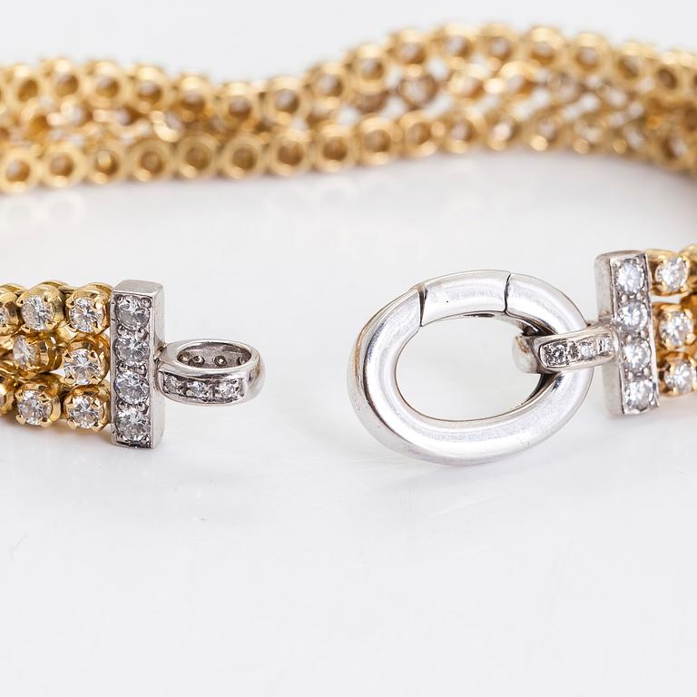 An 18K gold 3-strand tennisbracelet, set with brilliant-cut diamonds totalling approximately 10.54 ct.