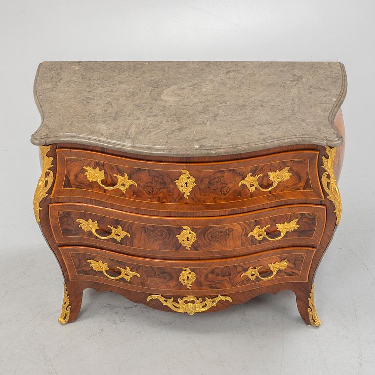 A Swedish rococo parquetry and gilt-bronze mounted commode in the manner of C. W. Hein, later part of the 18th century.