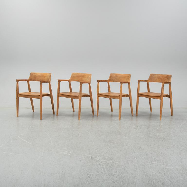 Four contemporary teak armchairs.