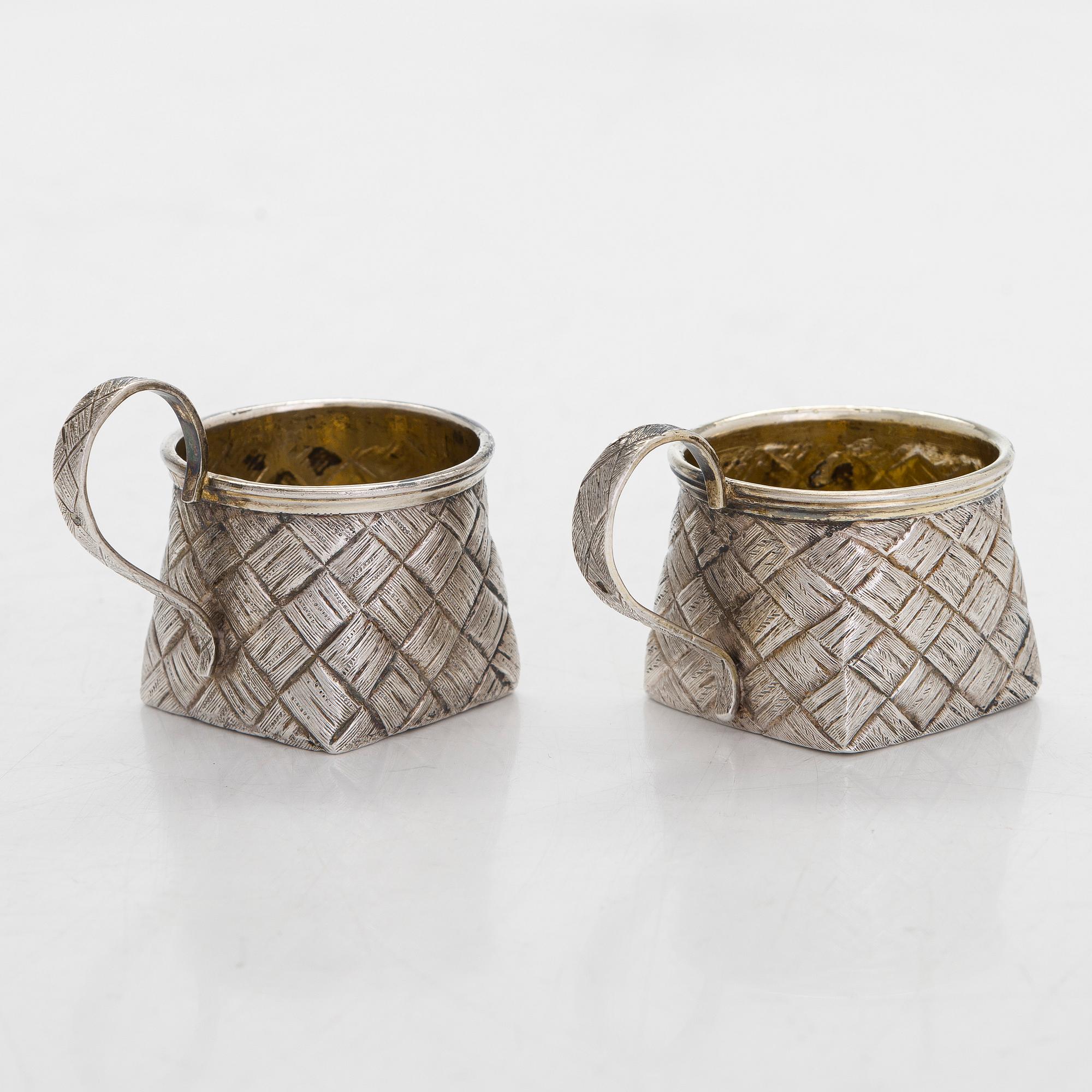 A silver and glass bottle with eight silver charka, maker marks of Pyotr Yermolajevich Davidov, Saint Petersburg, 1884.