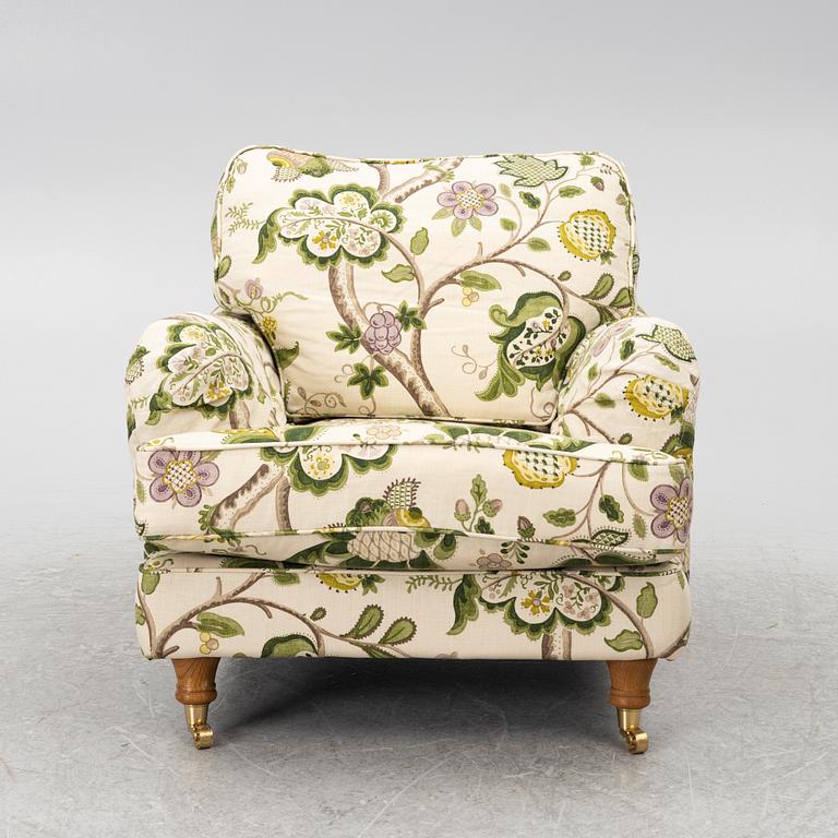 A 'Howard' armchair with footstool, Englesson.