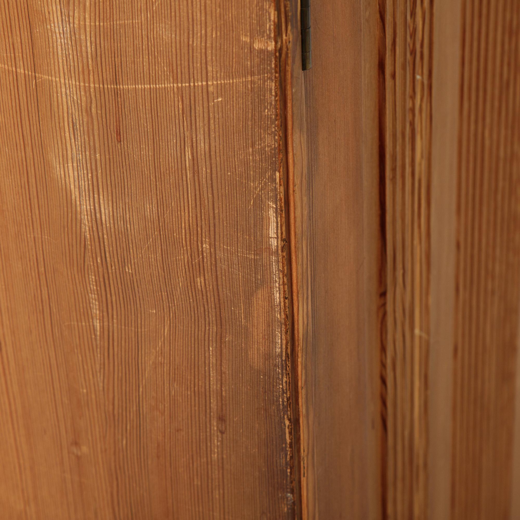 A pair of pine cupboards with shelves by Carl Malmsten.