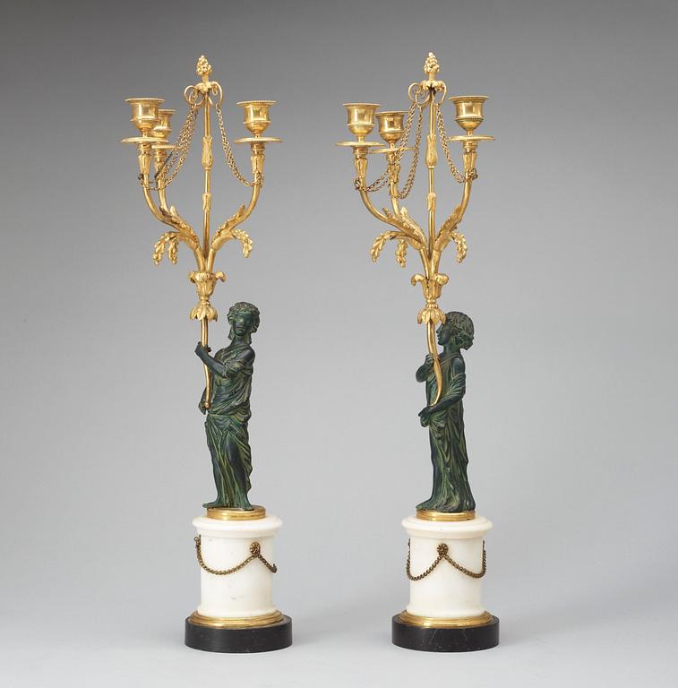 A pair of Louis XVI 18th century gilt and patinated bronze and marble three-light candelabra.