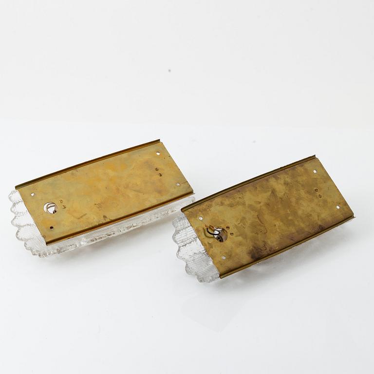 Carl Fagerlund, two brass and glass wall lights, Orrefors, later part of the 20th Century.