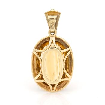 A pendant set with oval, mixed-cut citrine.