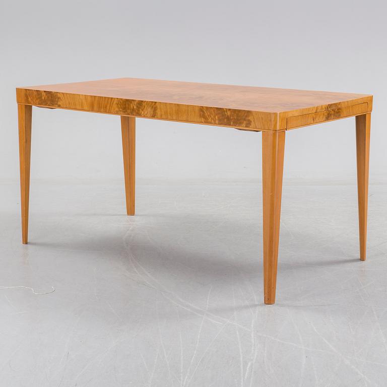 A 1940's dining table an four chairs.