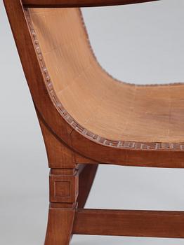 A Hjalmar Jackson pear wood and brown leather easy chair, Stockholm 1934,