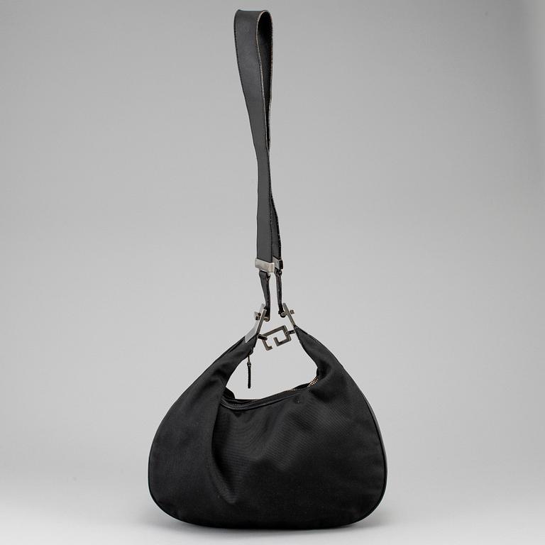GUCCI, a canvas handbag.