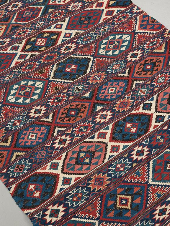 A CARPET, AN ANTIQUE AZERI KILIM, probably a Shirvan, ca 250 x 117,5 cm.