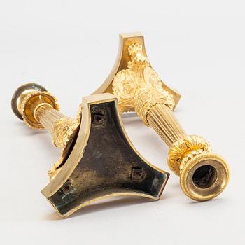 A pare of late empire candelsticks mid 19th century.