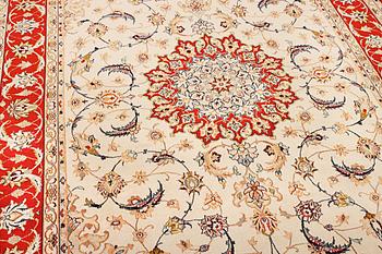 A semi-antique part silk Isfahan rug, a. 238 x 156 cm.