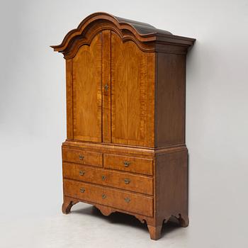 A late Baroque walnut-veneered cabinet in the manner of J. H. Fürloh, mid 18th century.
