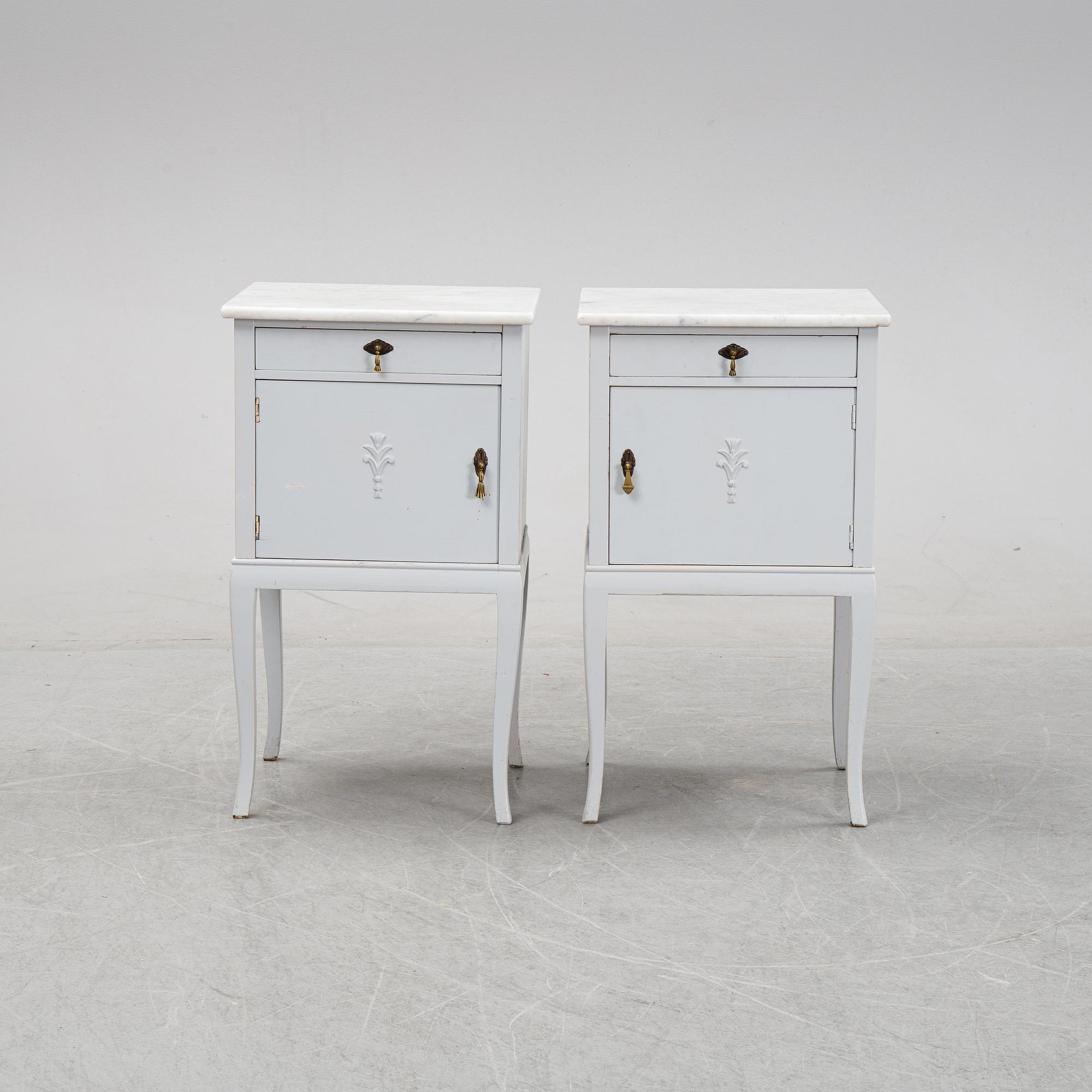 A pair of painted bedside tables with marble tops, 1920's.