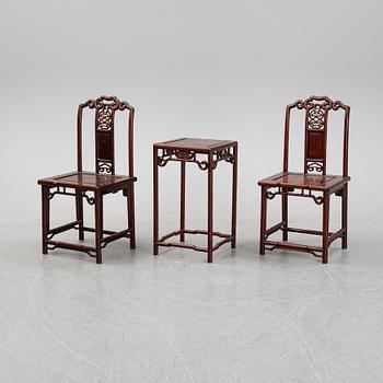 A pair of Chinese hardwood contemporary chairs and table.