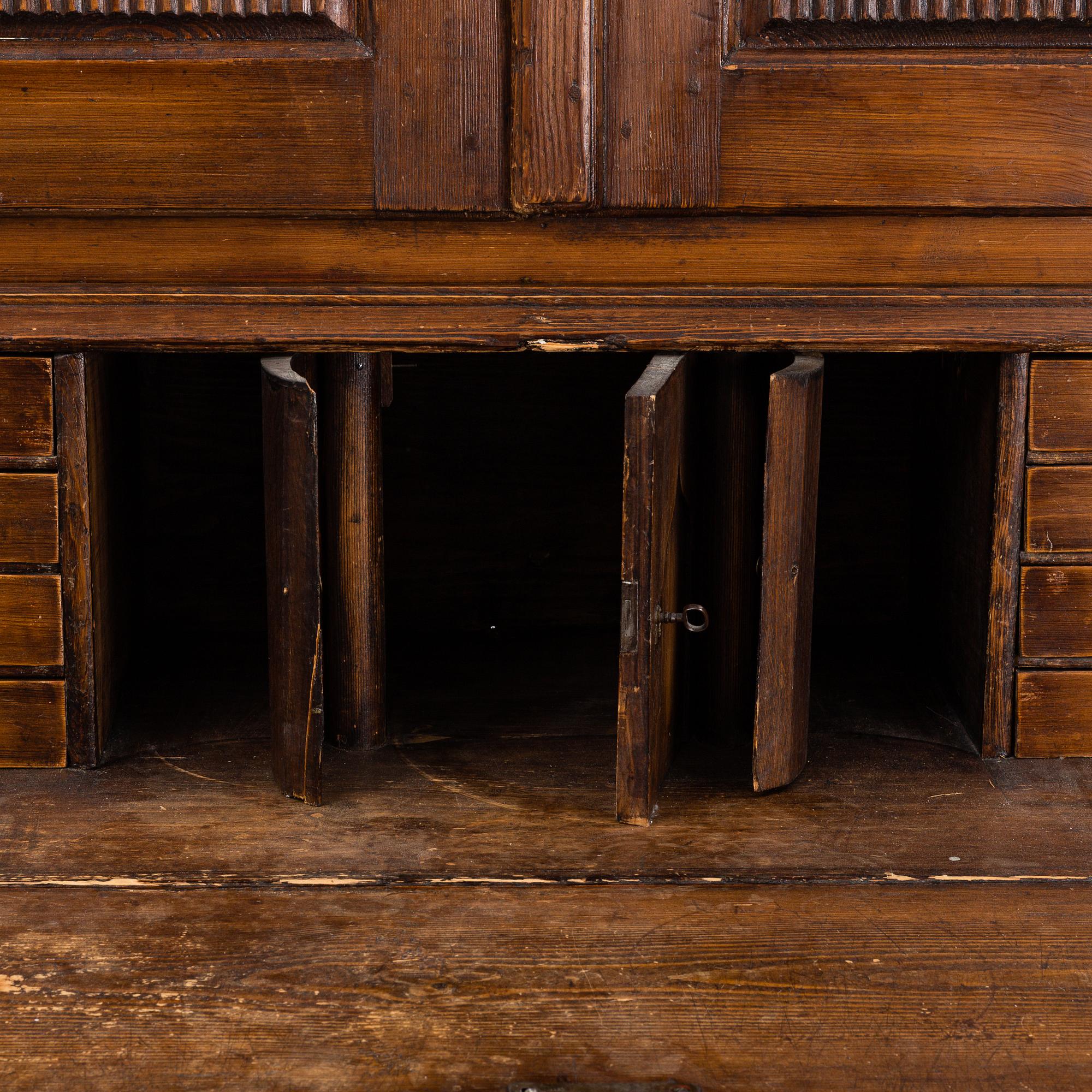 An early 19th Century pine cabinet.