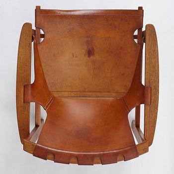 Carl-Axel Acking, a "Trienna" oak and natural leather easy chair, for Nordiska Kompaniet, Sweden 1960's.