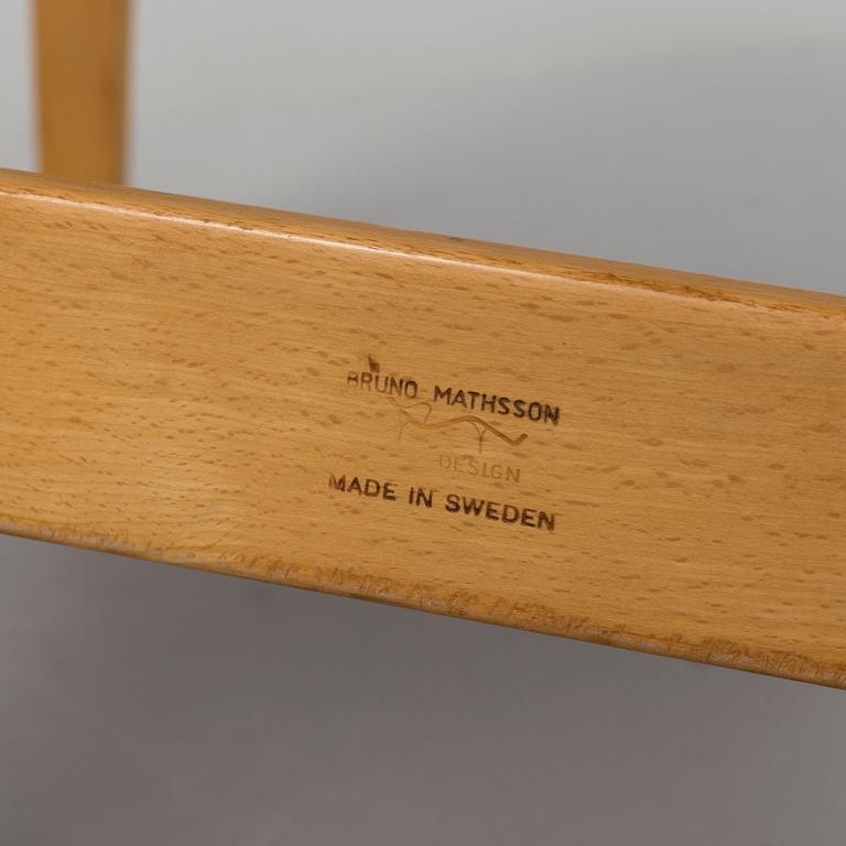 an "Eva" armchair by BRUNO MATHSSON 1963.