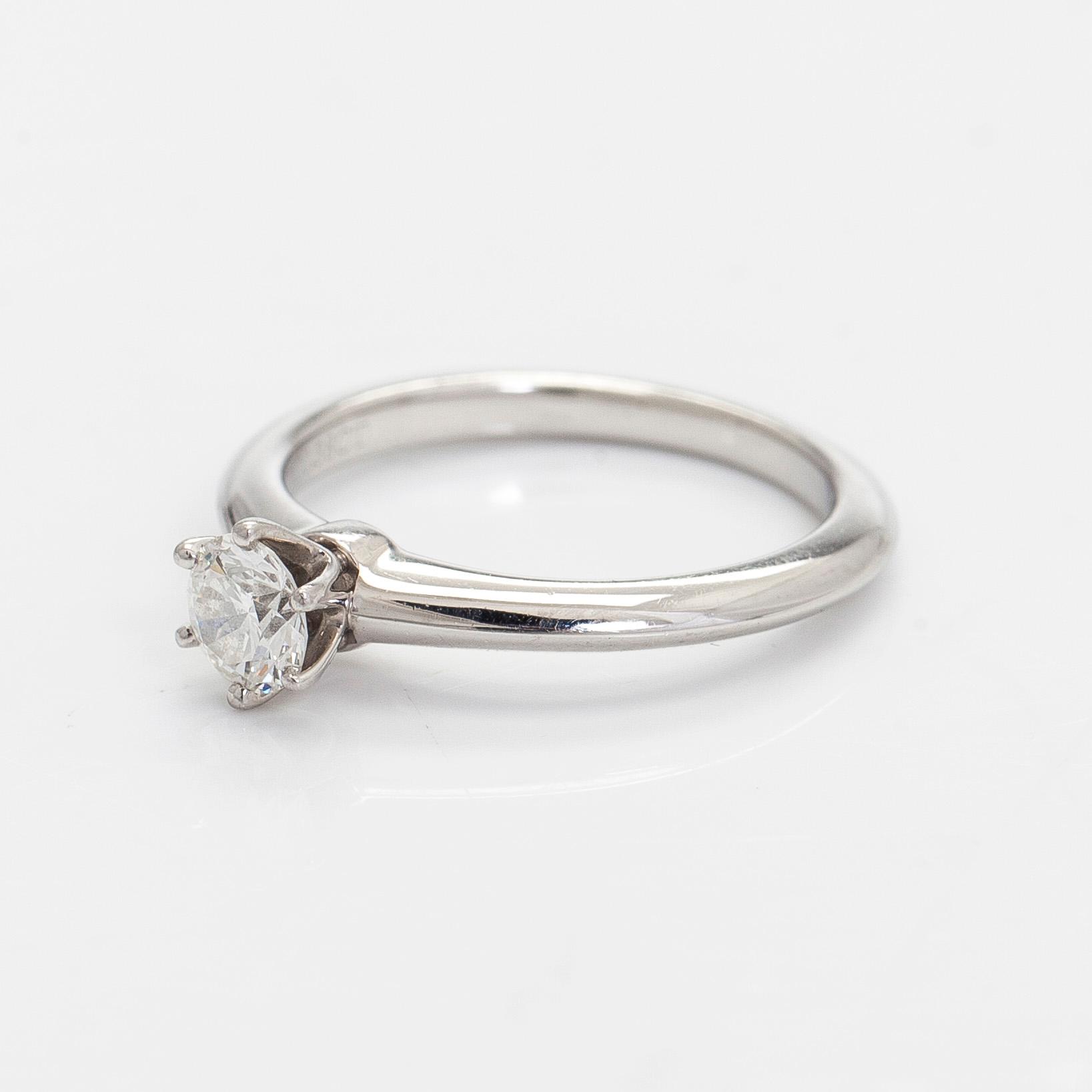 Tiffany & Co, a platinum solitaire ring with a brilliant-cut diamond.