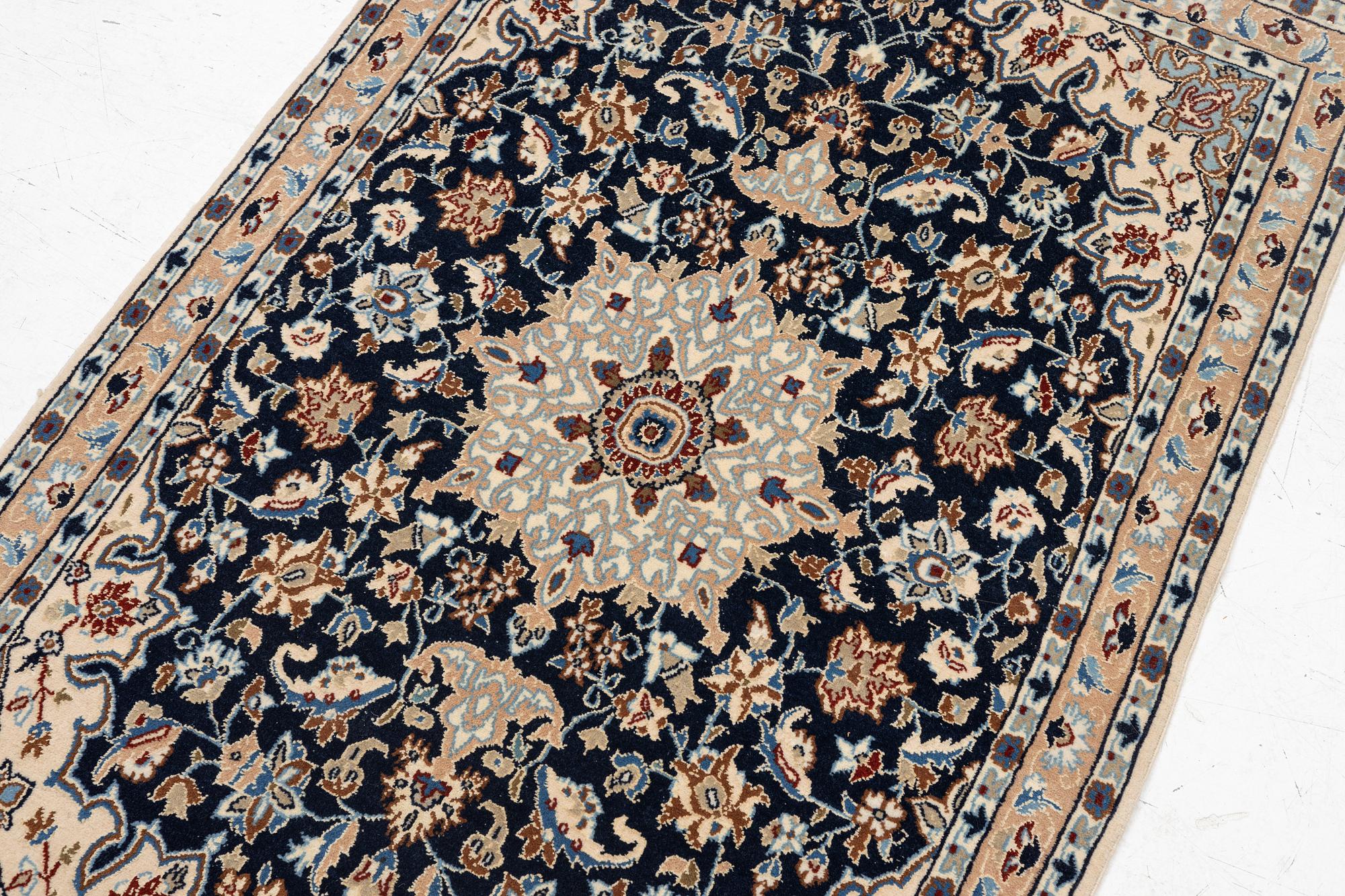 A Nain rug, part silk, c. 128 x 82 cm.
