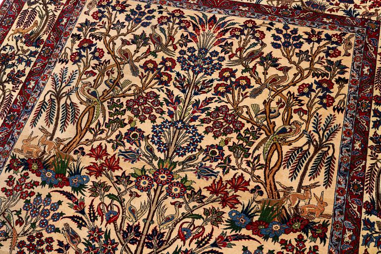 A semi-antique Qum carpet, Central Persia, c. 312 x 215 cm.