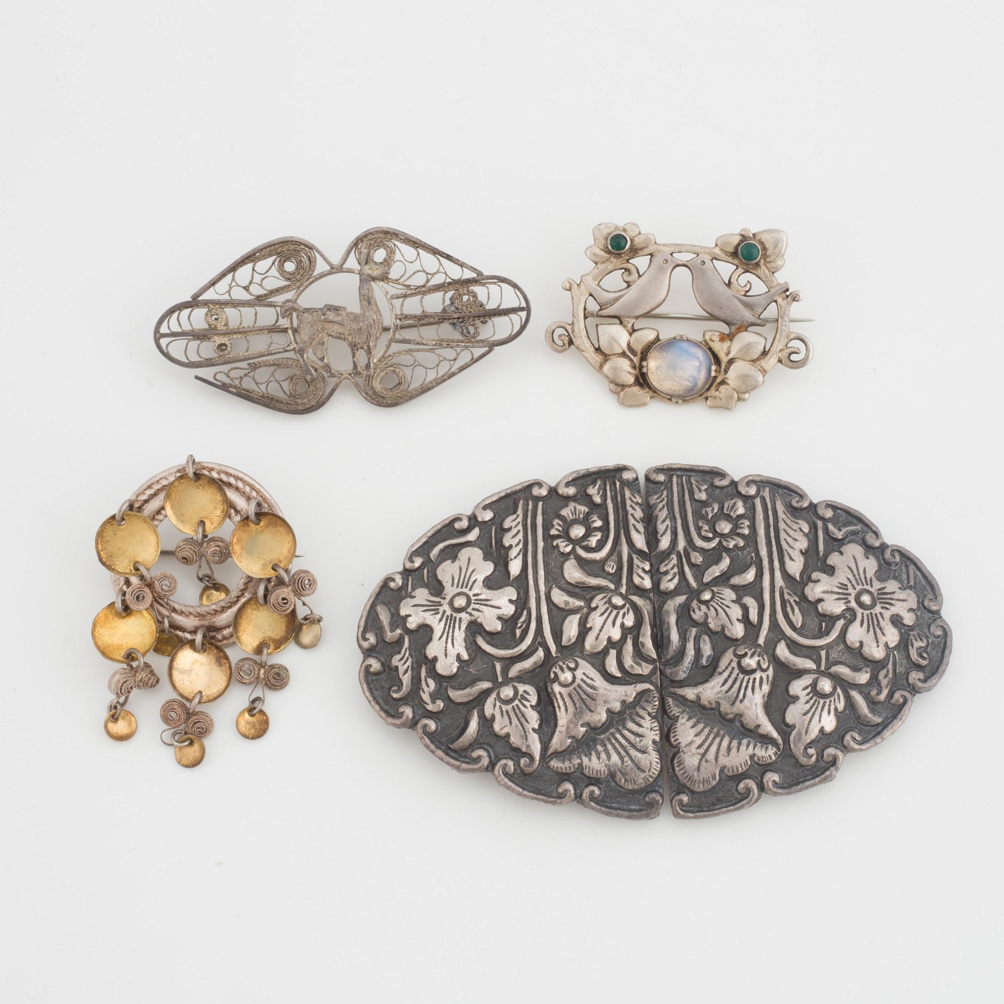 A silver belt buckle, three bracelets, two pairs of earrings, a pair of cuff-links and a brooch.
