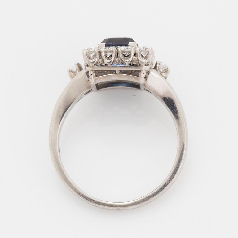 A platinum ring set with a faceted sapphire.