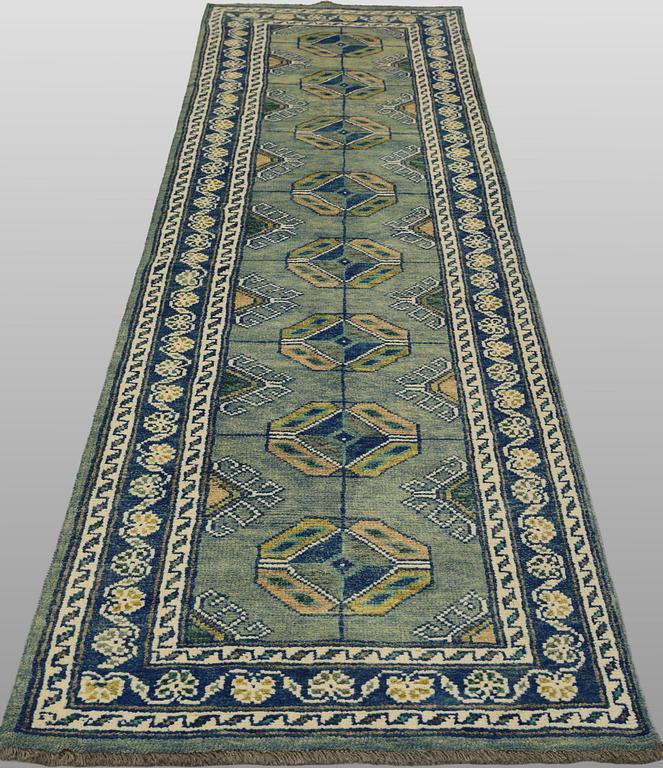 An Oriental runner, c. 296 x 77 cm.