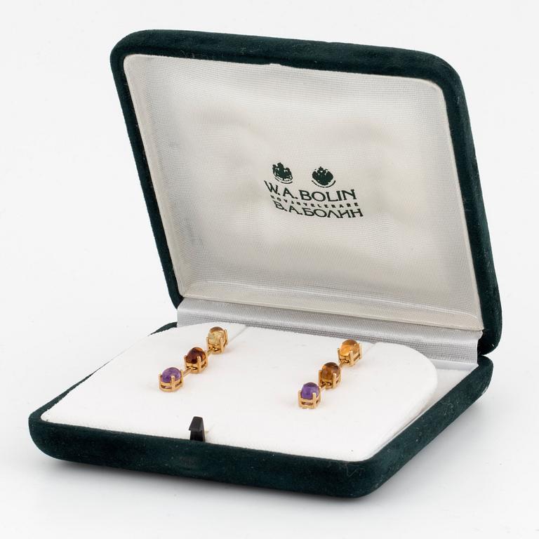 A pair of 18K gold earrings set with cabochon-cut citrines and amethysts.