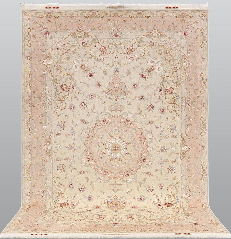 A Tabriz part silk carpet, signed, 305 x 203 cm.