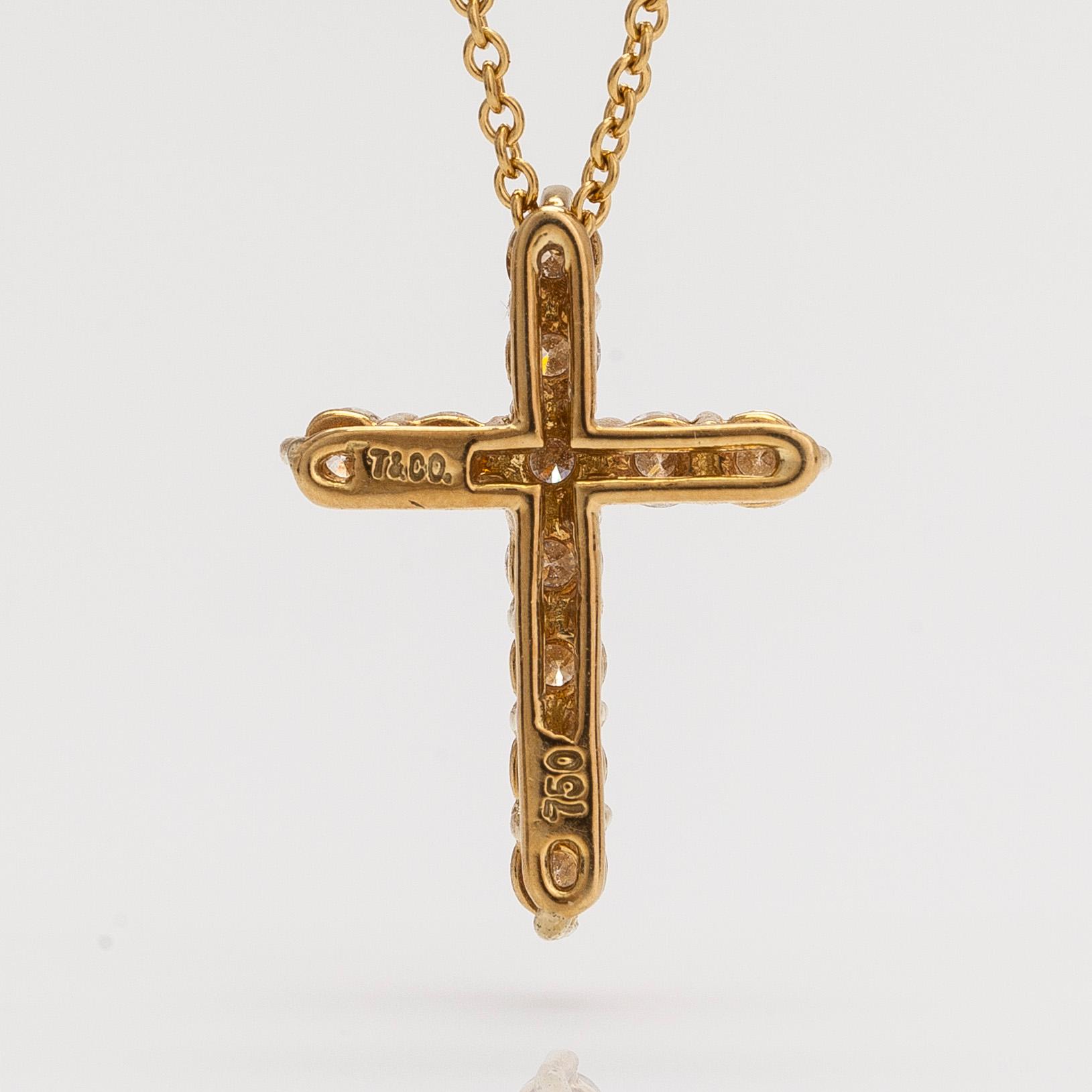 Tiffany & Co, an 18K gold cross pendant necklace with diamonds, ca. 0.42 ct in total.