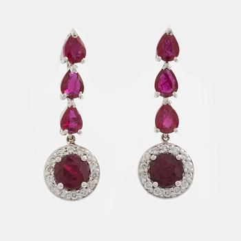 A pair of 18K gold earrings with faceted rubies and round brilliant-cut diamonds.